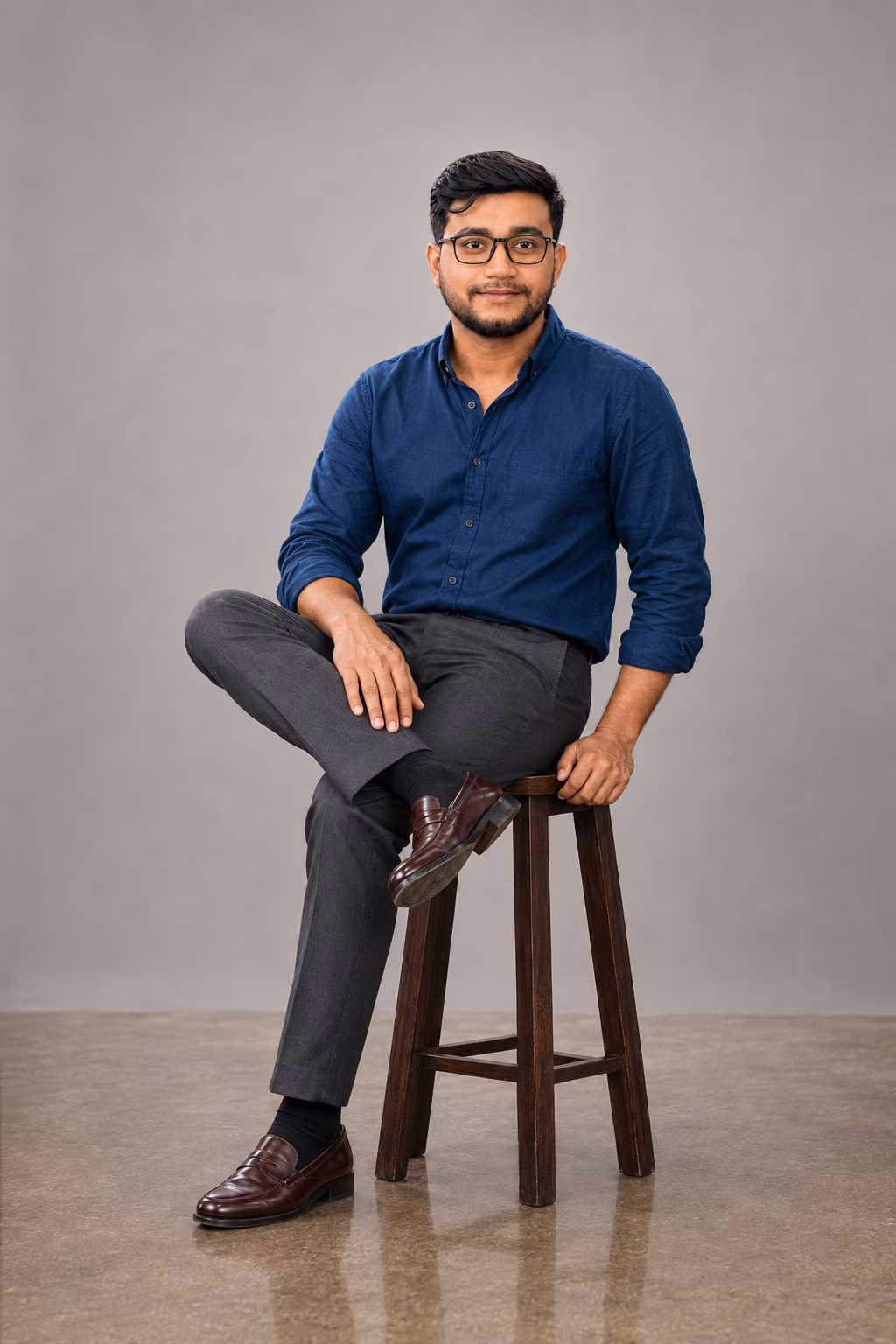 Aman Asghar seated in a studio portrait